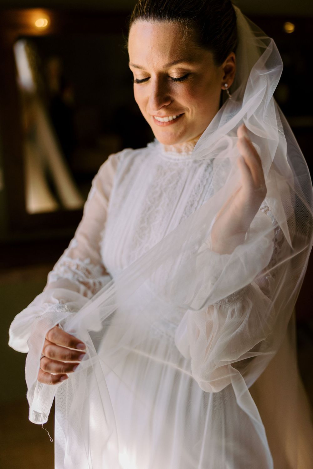 Close-up details of delicate white wedding dress with ruffled tulle fabric.