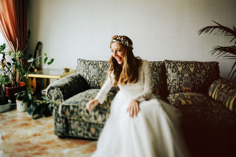 A bridal portrait showing an elegant white dress against vintage floral furniture.