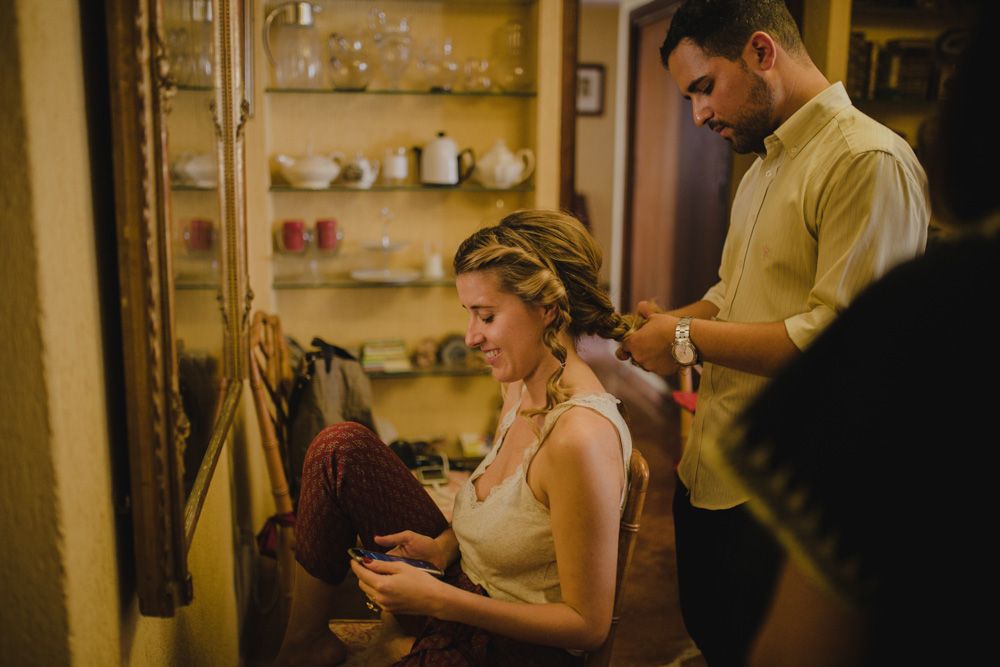 Getting ready scene showing final wedding preparations in a warm-lit room.