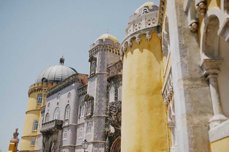 Architectural detail of Pena Palace showing contrasting yellow and grey stone towers and domes.