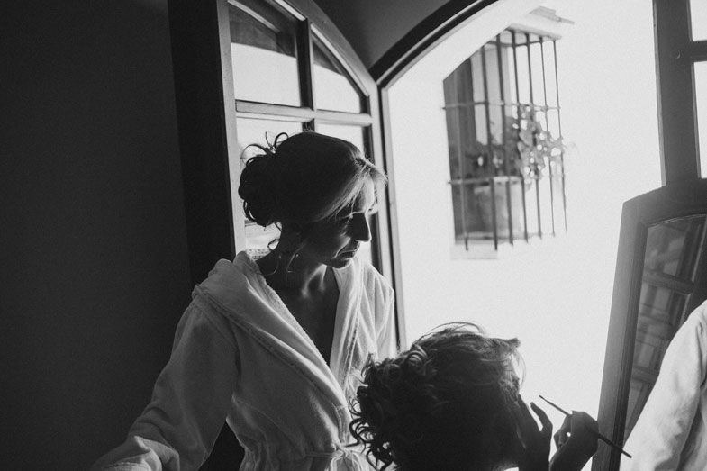 Behind the scenes shot of wedding preparations in black and white.
