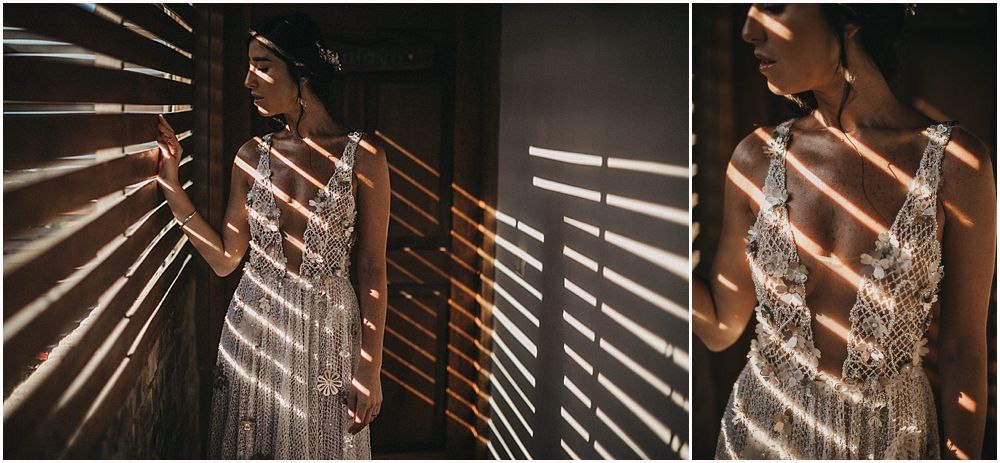 Artistic shadows from window blinds create patterns on a flowing wedding dress.