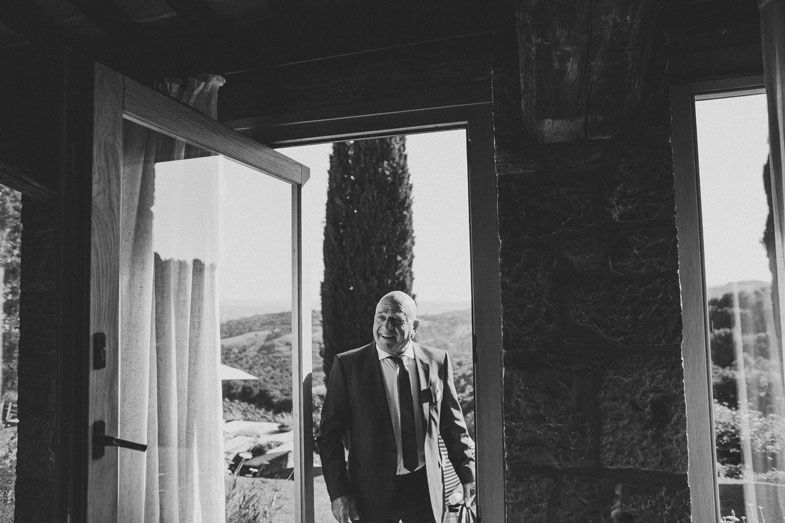 Black and white photo showing silhouettes in a doorway of an old stone building.