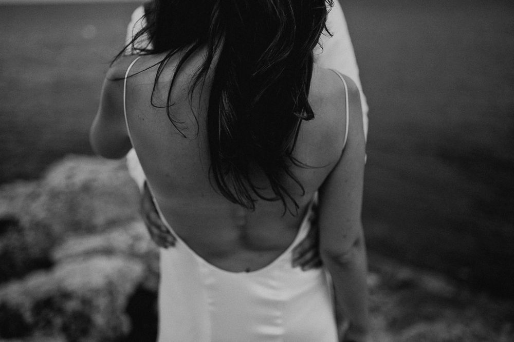 Black and white portrait showcasing elegant backless dress design.