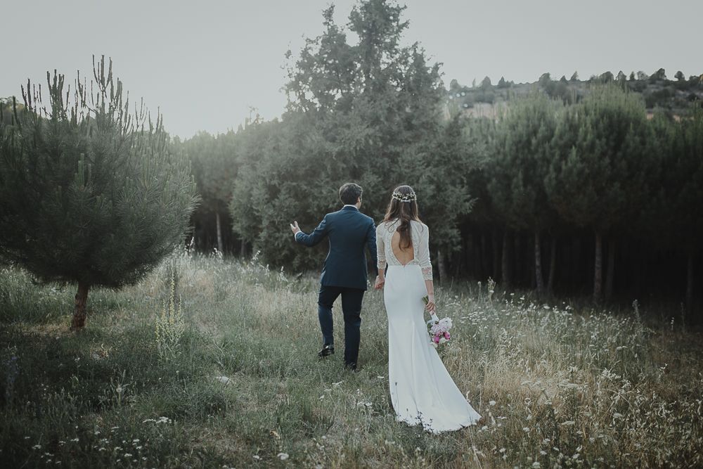 A couple shares an intimate moment in a dreamy mountain meadow during their wedding.