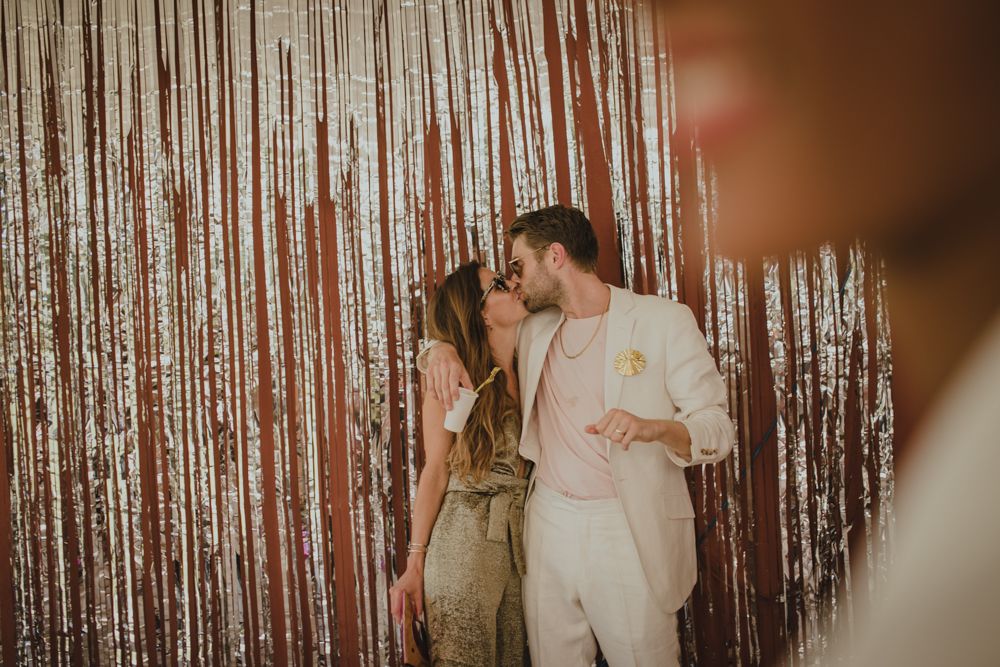 Romantic moment captured against a sparkly metallic backdrop.