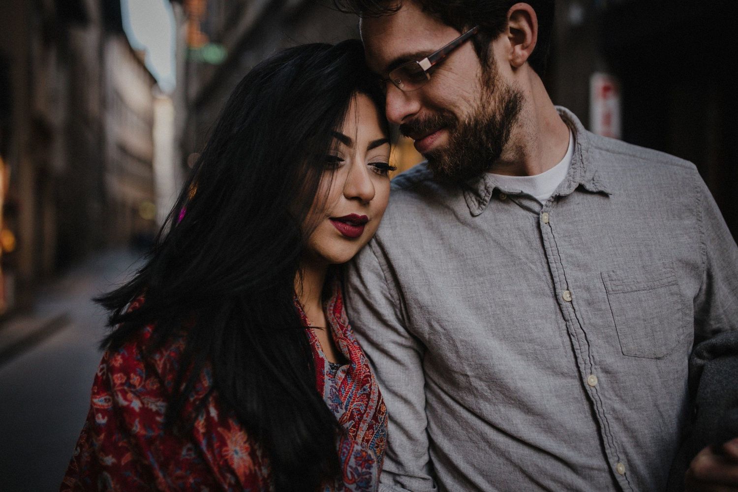 Intimate urban portrait in warm evening light showing gentle affection.