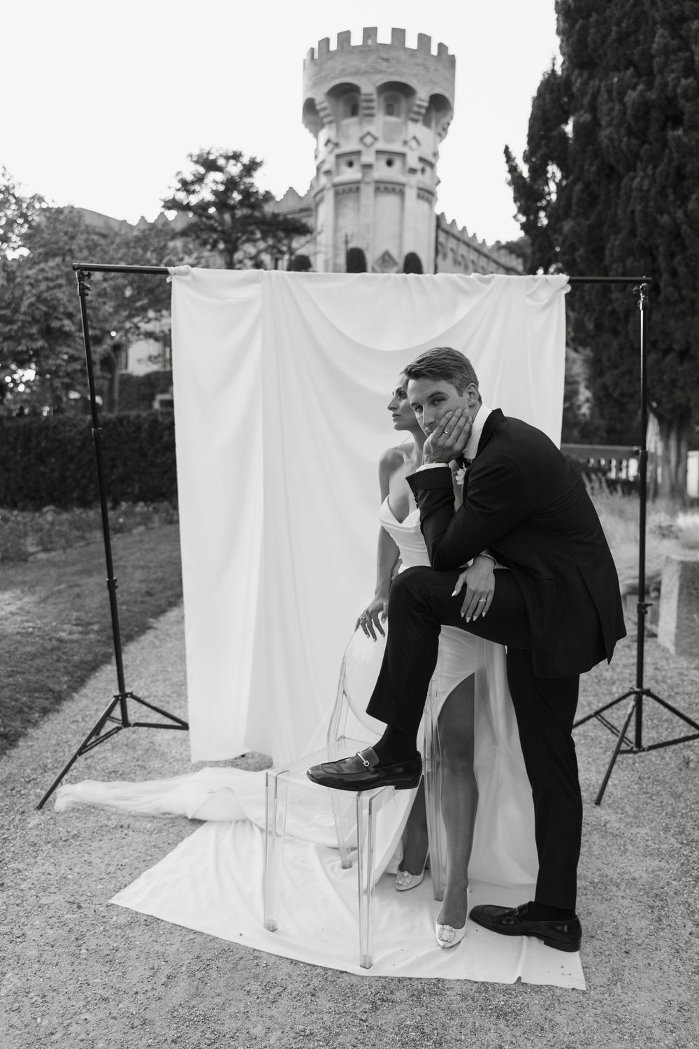Creative wedding photo series showing guests posing behind white backdrops in an outdoor castle setting.