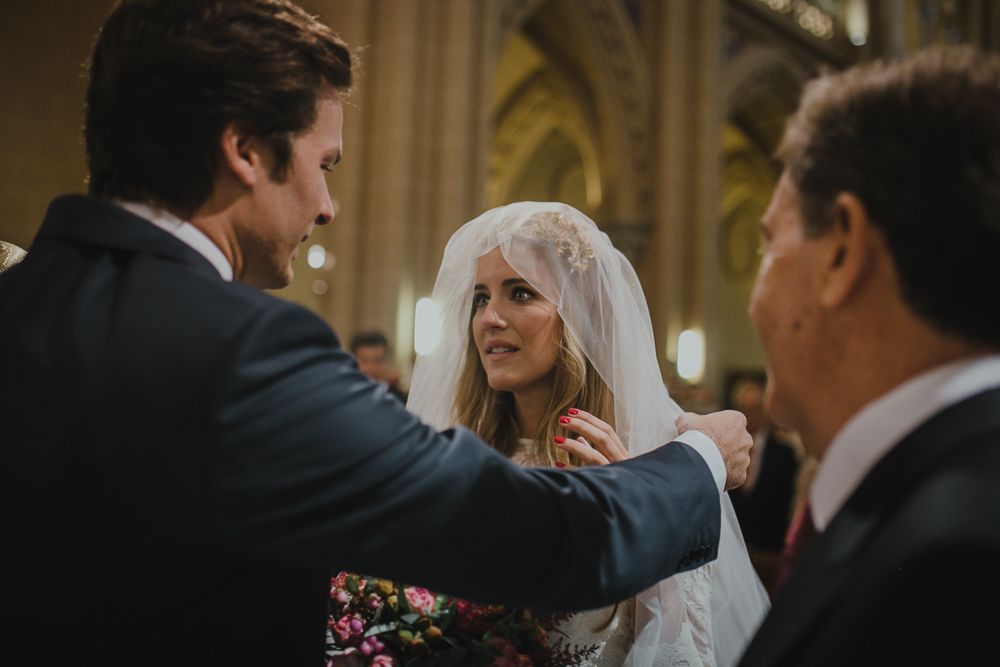 An intimate moment captured during a traditional wedding ceremony inside a church.
