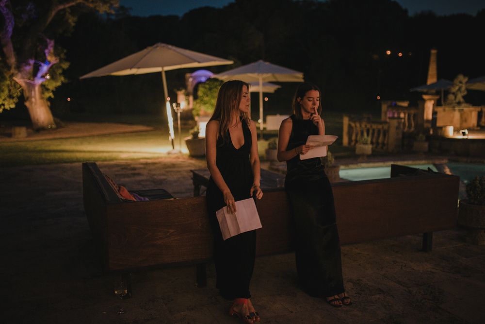 Evening outdoor catering setup with umbrellas and buffet tables.