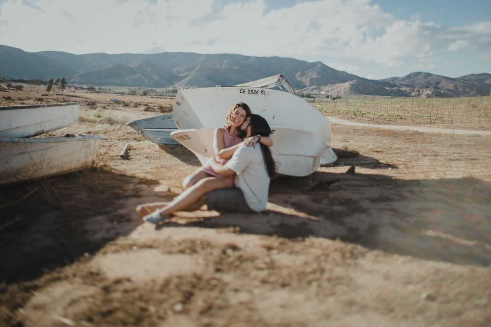A romantic desert scene with vintage boats and mountains in the distance.