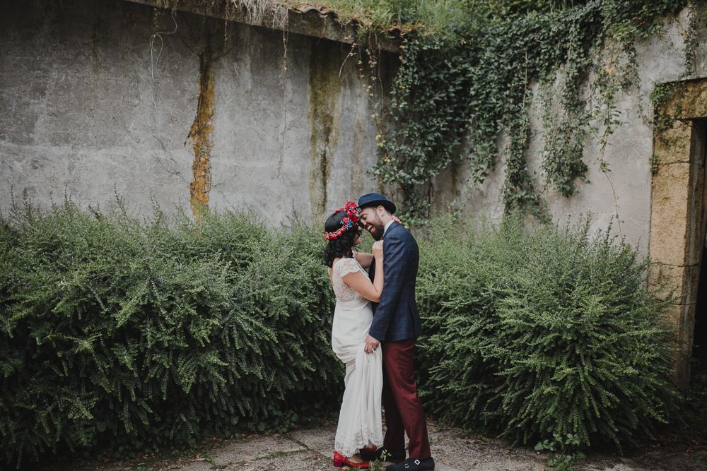 Intimate wedding portrait in walled garden with climbing vines and ferns.
