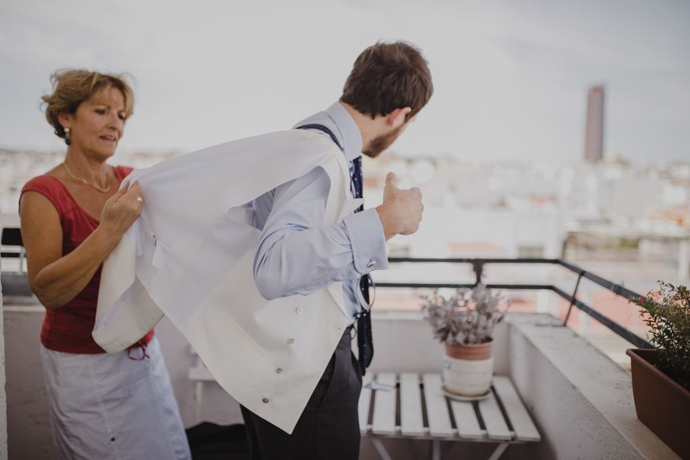 Getting ready scene on a rooftop terrace with light and airy atmosphere.
