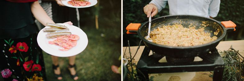 Wedding reception food being served on platters and cooked in a large pan outdoors.