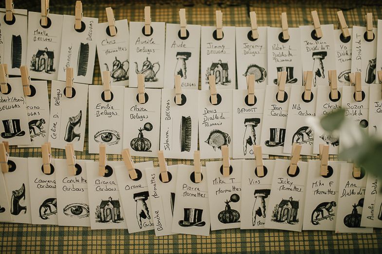 Calendar pages with vintage-style illustrations hung on display with clips.