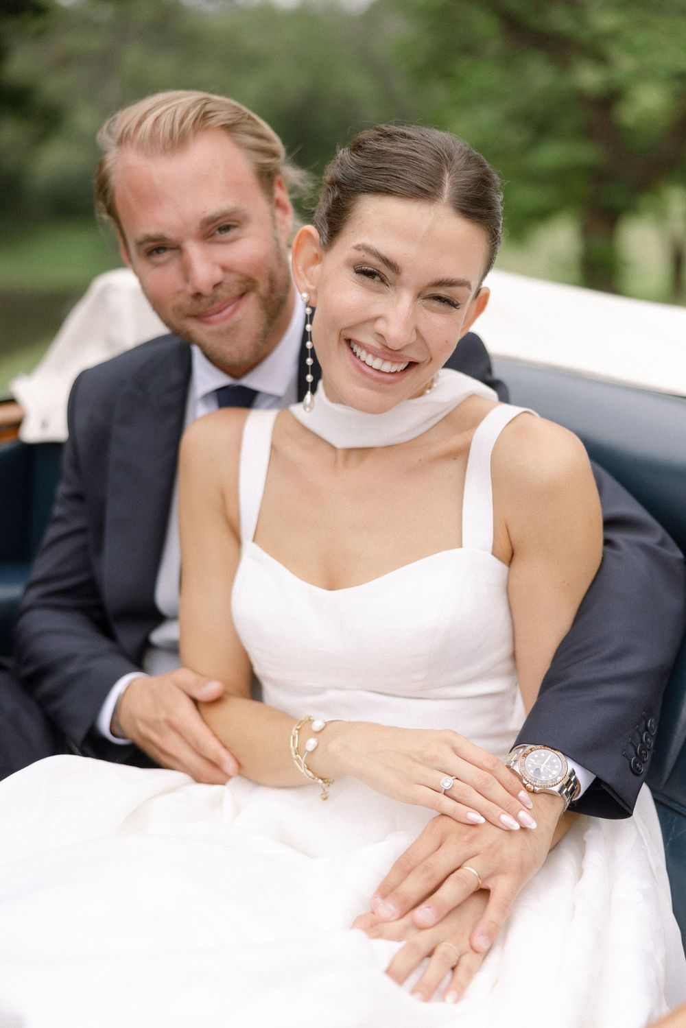 Candid wedding moment captured outdoors with natural lighting and joyful expressions.