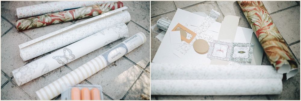 Rolled paper documents with gold text detail on light surface.