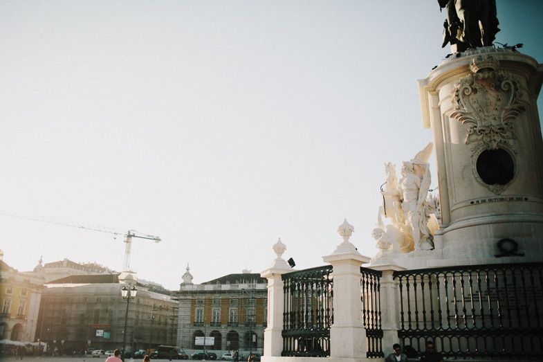 Ornate monument with construction crane visible in city square.