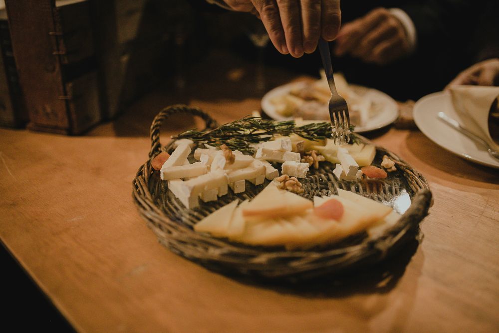 Close-up of someone cutting into a decorated pie or pastry on rustic table.