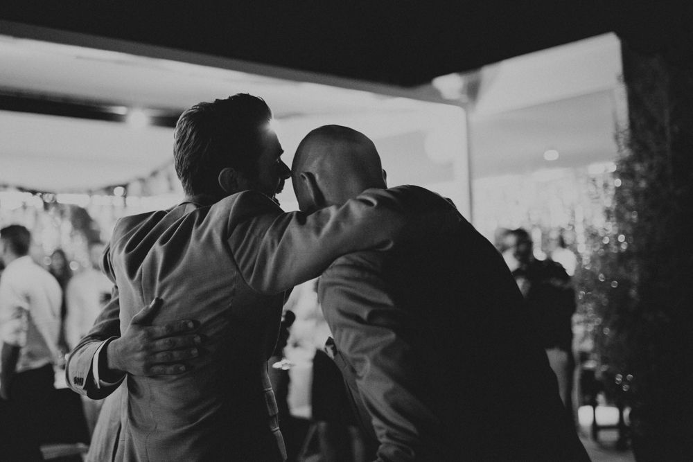 Two people share an intimate embrace during a nighttime celebration.