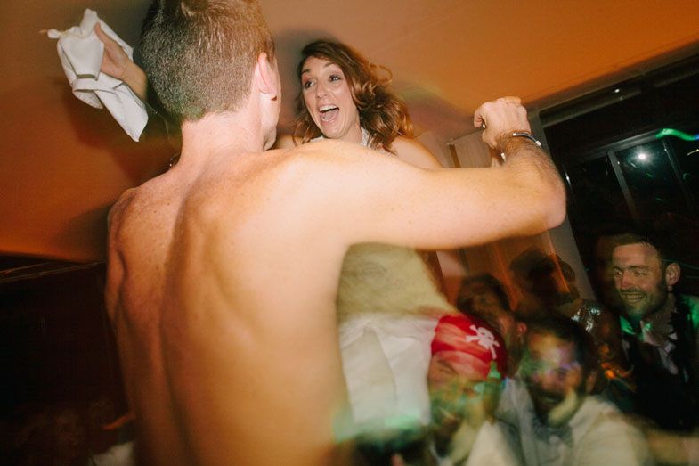 Energetic dancing and celebration captured at a lively wedding reception party.