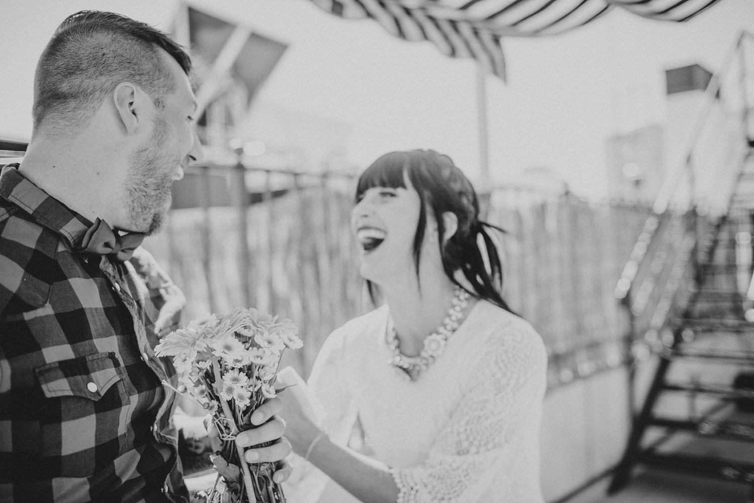 Black and white outdoor photo showing joyful interaction with flowers.