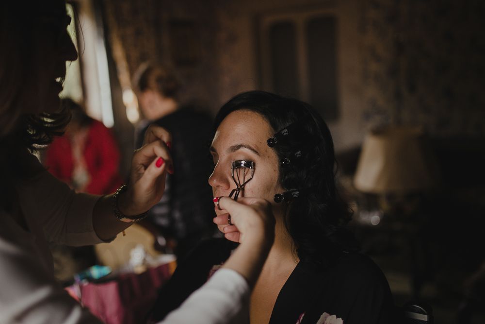Getting ready scene in vintage room with floral dress and antique furniture.