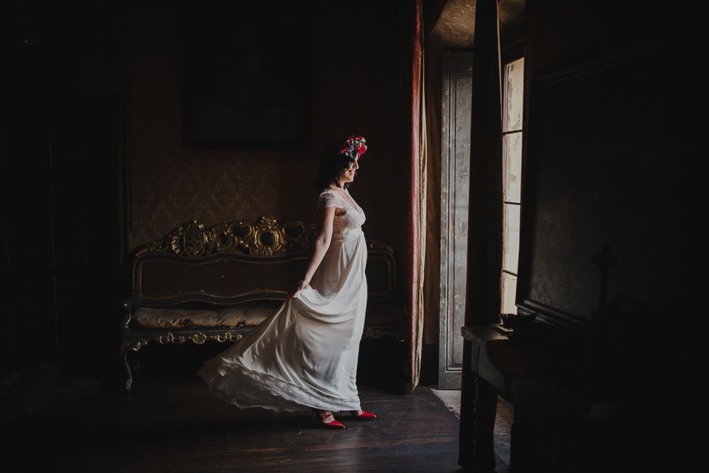 Artistic silhouette of a flowing white dress against a dark interior with window light.