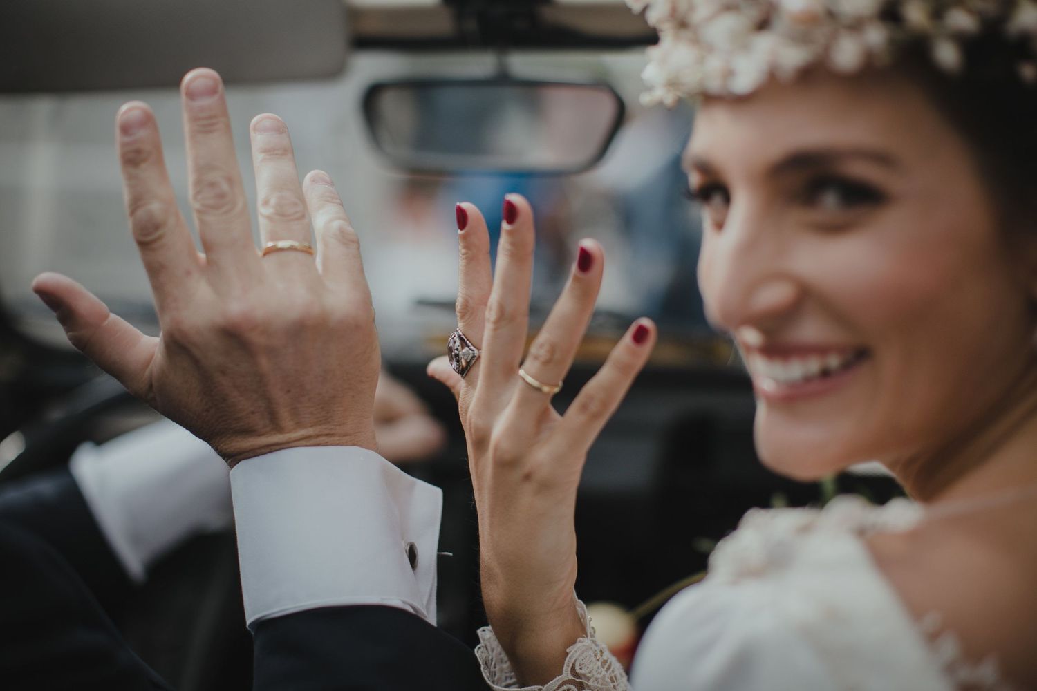 Close-up of newly married couple's hands showing wedding rings.