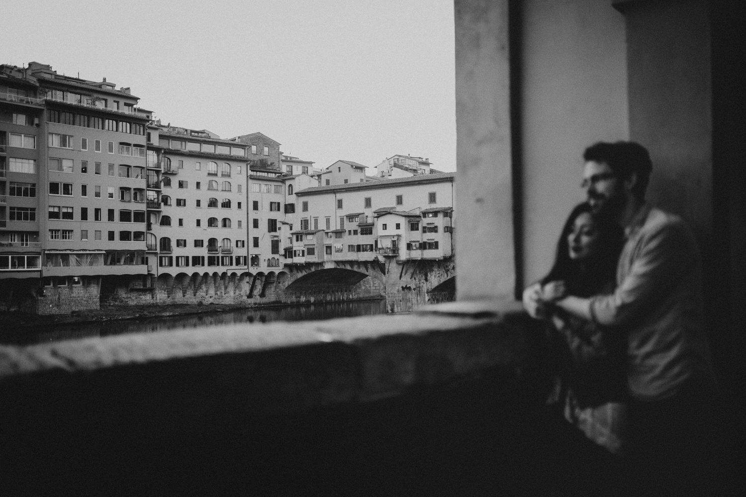 Black and white photo of couple overlooking Florentine architecture.