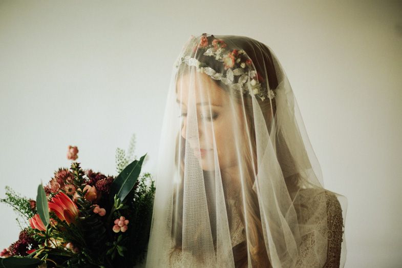 A delicate bridal veil adorned with floral crown creates a romantic silhouette.