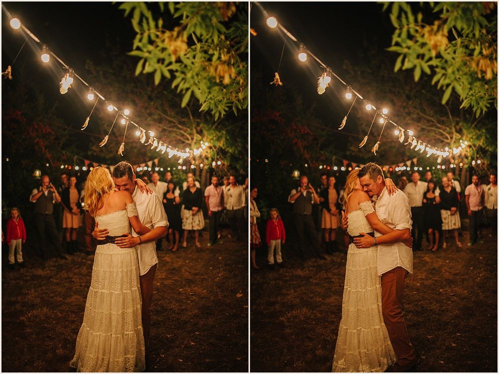 Romantic outdoor celebration under string lights with tree foliage overhead.