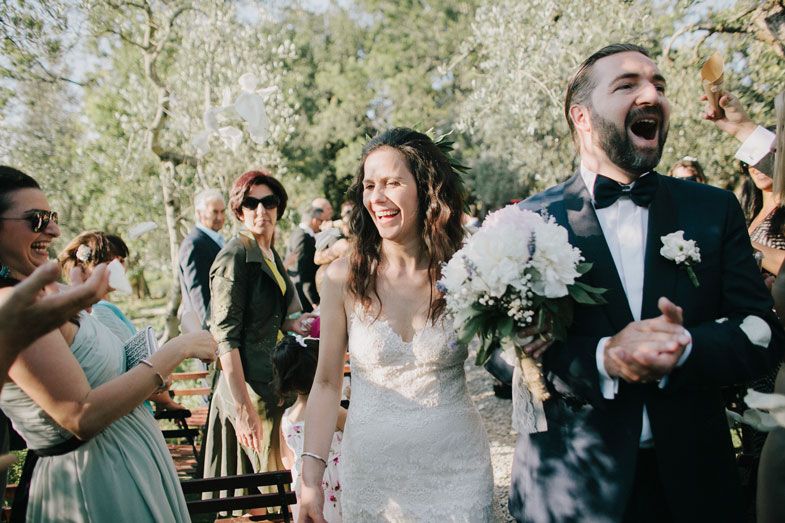 Guests gather for celebrations in a beautiful stone archway setting.