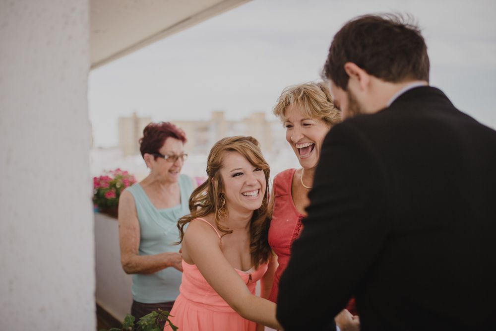 A joyful wedding celebration moment on a bright terrace.