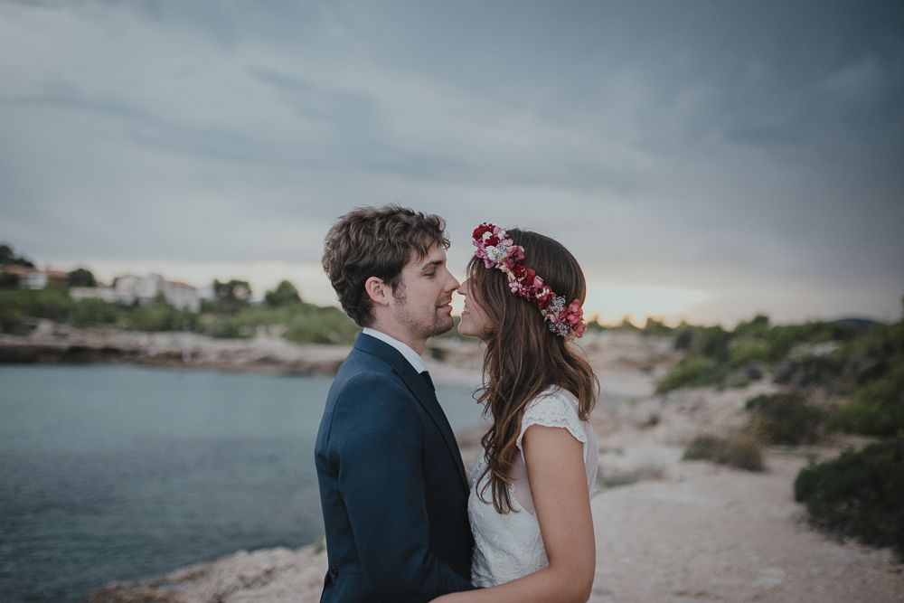Intimate wedding portrait of a couple on a coastal landscape.