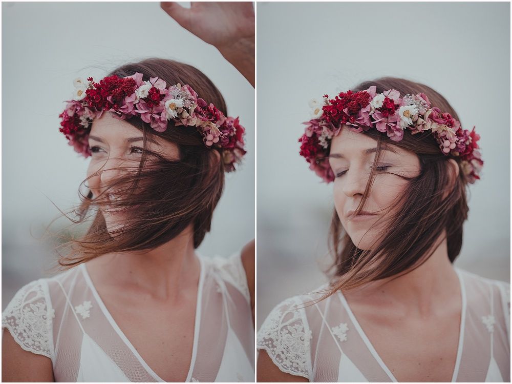 Wind-swept portrait with pink floral crown and lace wedding dress details.