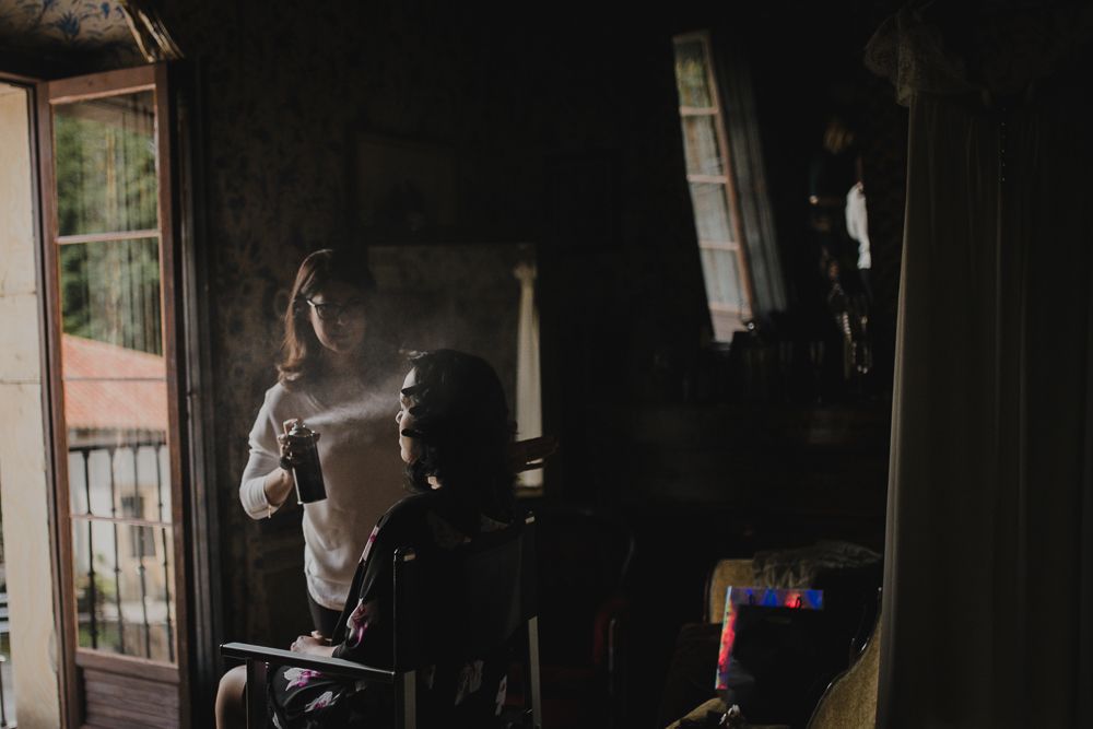 Figure silhouetted against window light in vintage interior setting.