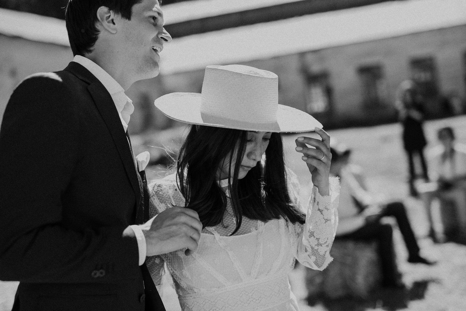 A joyful moment captured at an outdoor celebration with bright sunlight.