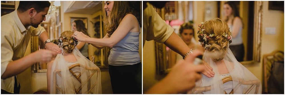 Close-up of hands placing a delicate crown on display during wedding preparations.