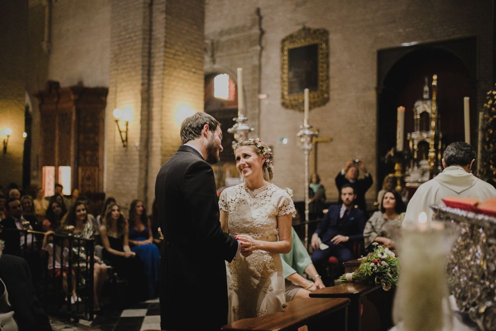 Wedding ceremony in a historic church with ornate architecture and candlelight.