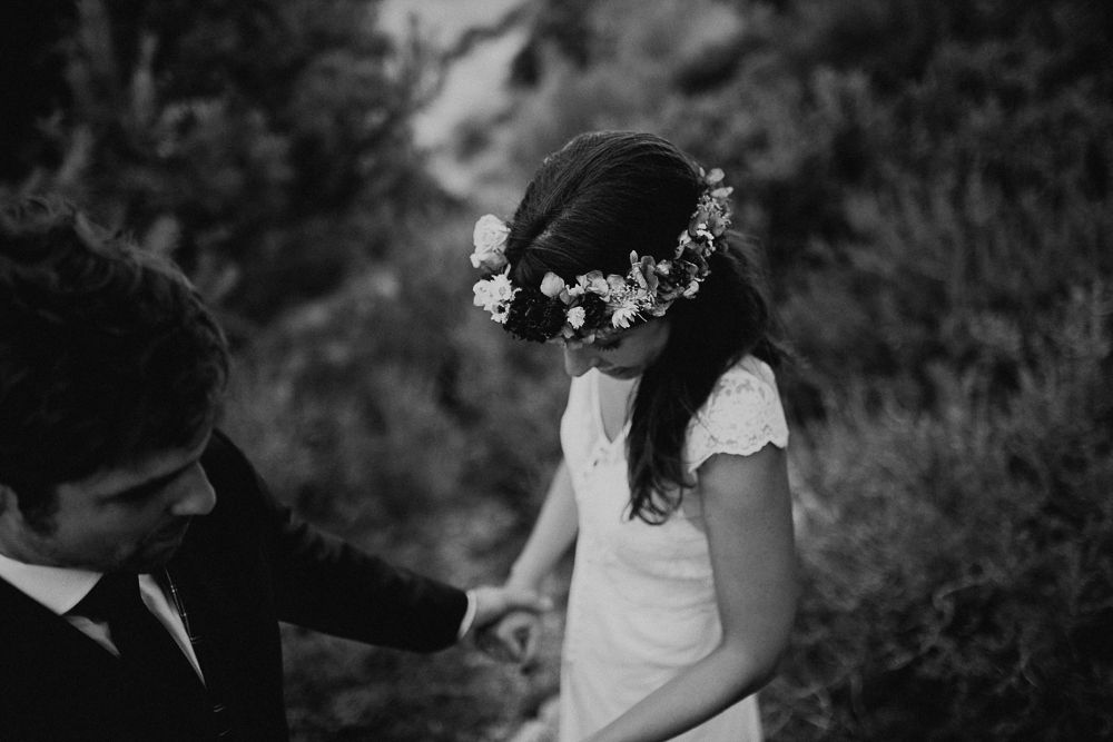 A black and white wedding photo showing an intimate moment in nature.