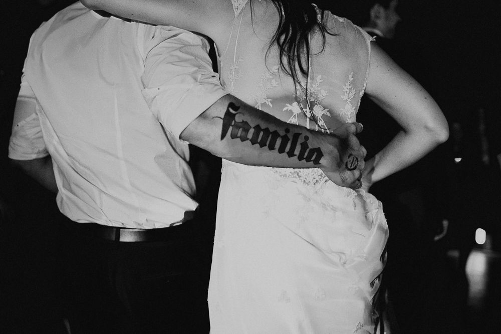 Black and white close-up of formal attire details during a dance.