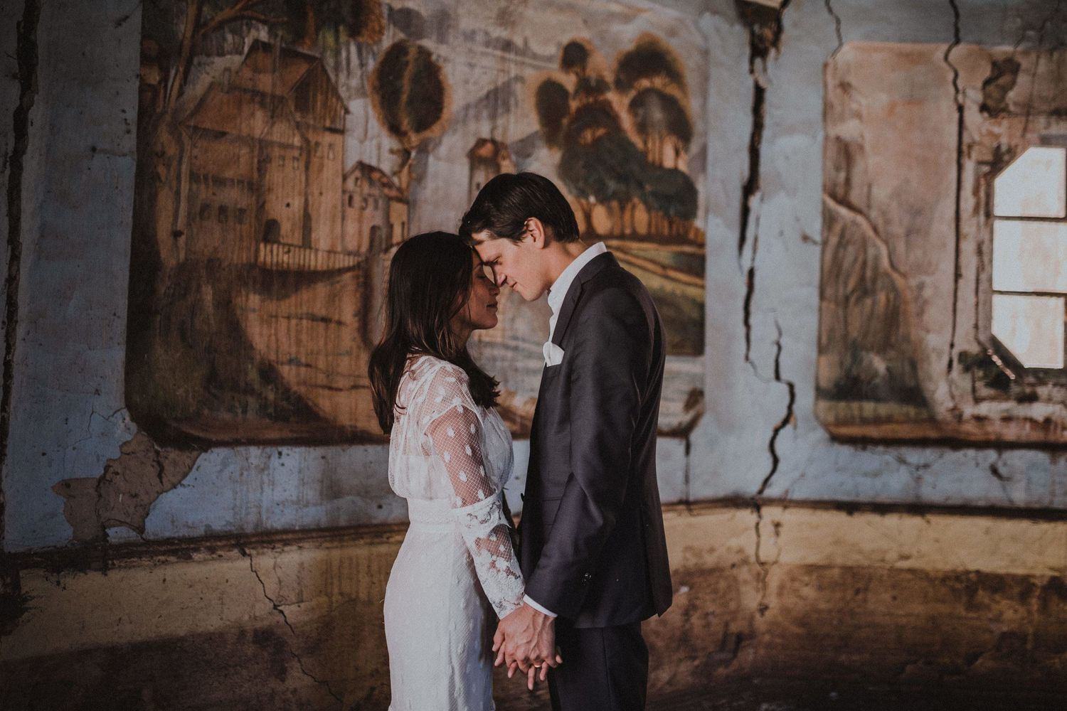 Romantic moment in vintage room with decorative wall paintings.