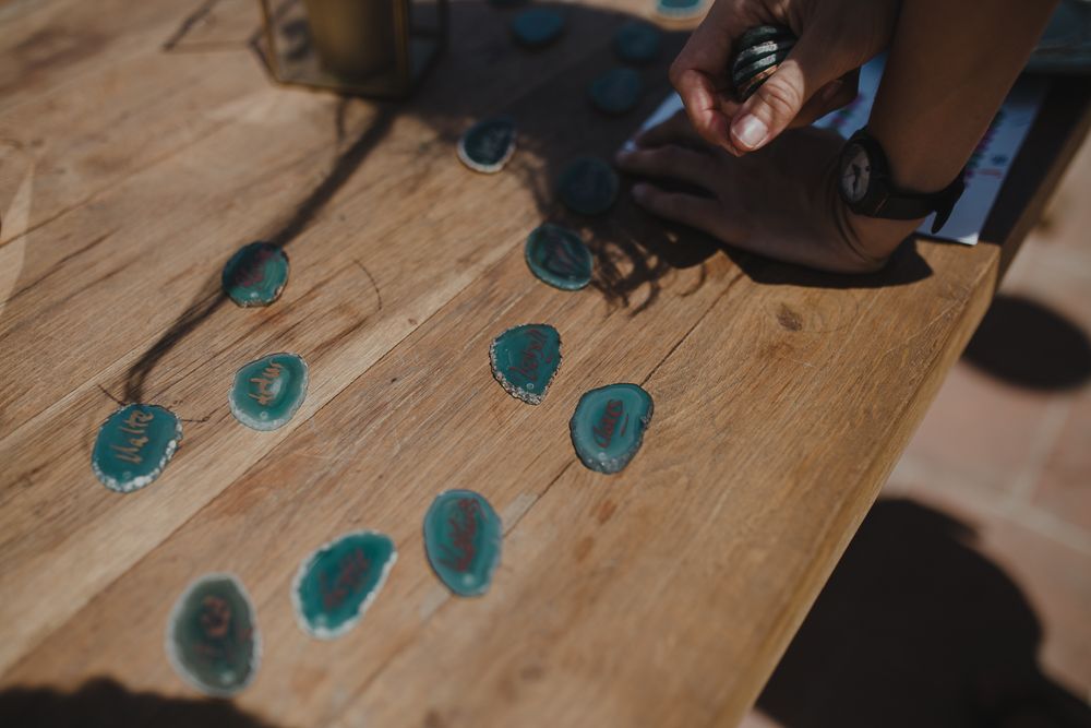 Turquoise paint drops splattered on a wooden surface.