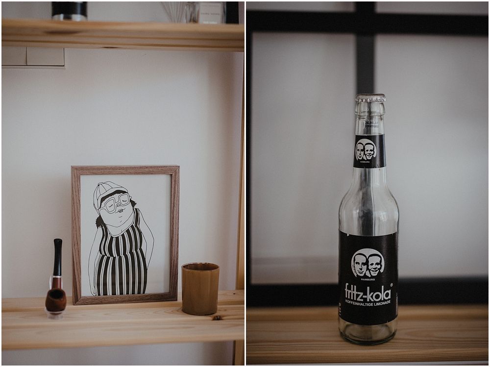 Minimalist shelf display with line drawing and dark bottle.