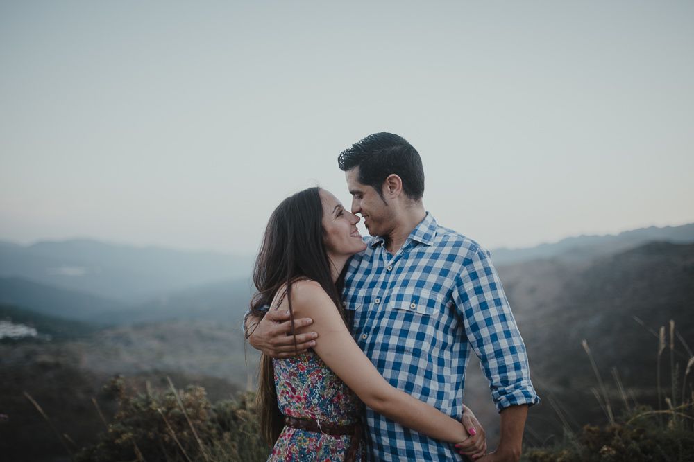 Intimate couple portrait captured against a mountainous backdrop during golden hour.