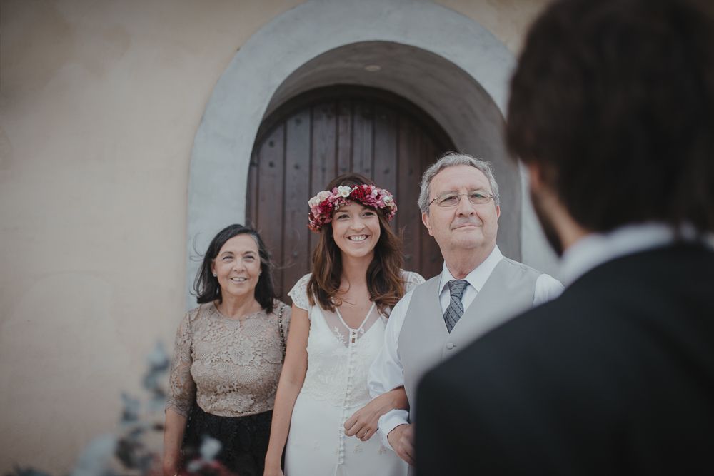 Elegant wedding scene with decorative floral crown and arched doorway.