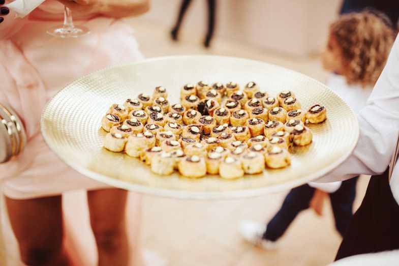 A plate of elegant miniature desserts being served at a wedding reception.