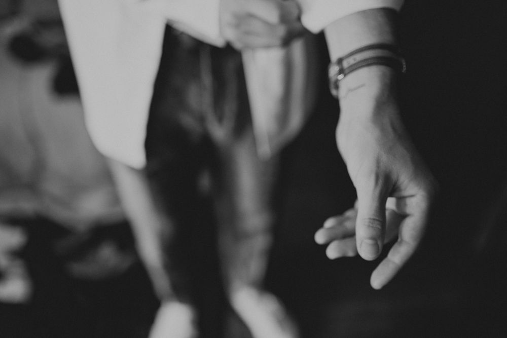 Close-up black and white shot of hands with rings and bracelets.