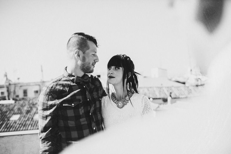 Black and white photo of couple sharing tender moment on rooftop.